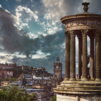 "Framed photograph of Edinburgh's skyline under a cloudy sky, featuring historic landmarks."